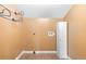 Small laundry room with tile floors, white storage cabinet, and goldenrod walls at 611 N Garfield Ave, Deland, FL 32724