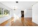 Bright living room features hardwood floors, white walls, and large windows at 611 N Garfield Ave, Deland, FL 32724