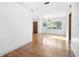 Bright living room with beautiful hardwood floors, large windows, and white trim at 611 N Garfield Ave, Deland, FL 32724
