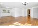 Spacious living room features wood floors, bright white walls, and neutral colors at 611 N Garfield Ave, Deland, FL 32724