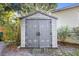 Outdoor storage shed with double doors, surrounded by greenery at 611 N Garfield Ave, Deland, FL 32724