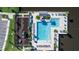 Aerial view of the community pool and playground, complete with lush landscaping and modern amenities at 614 Becklow St, Debary, FL 32713