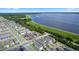 Aerial view of a neighborhood near a lake, showing property lines and landscaping at 614 Becklow St, Debary, FL 32713