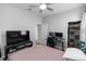 Relaxing bedroom with a ceiling fan, closet and desk for work or study, all in a comfortable setting at 614 Becklow St, Debary, FL 32713