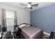 Cozy bedroom with a ceiling fan, a desk, and a window creating an inviting atmosphere at 614 Becklow St, Debary, FL 32713