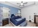 Comfortable bedroom with blue accents, ceiling fan, and plush bedding at 614 Becklow St, Debary, FL 32713