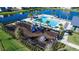 Community pool and playground, featuring a modern pool, seating, and playground for recreation at 614 Becklow St, Debary, FL 32713