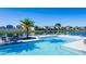 Picturesque community pool featuring crystal-clear water and relaxing lounge chairs alongside a scenic lake at 614 Becklow St, Debary, FL 32713