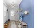 Bright foyer featuring stylish decor, a decorative light fixture, and a charming blue accent wall at 614 Becklow St, Debary, FL 32713