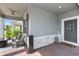 Inviting front porch with comfortable seating, brick flooring, and a ceiling fan at 614 Becklow St, Debary, FL 32713