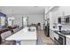 Open concept kitchen with a large island, stainless steel appliances, and seamless flow into the dining and living areas at 614 Becklow St, Debary, FL 32713