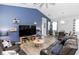 Open-concept living room with blue accent wall, stylish furniture, and ample natural light at 614 Becklow St, Debary, FL 32713