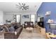 Cozy living room featuring leather seating, ceiling fan, and modern decor at 614 Becklow St, Debary, FL 32713