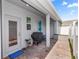 Covered patio with brick flooring, grill, and seating area for outdoor dining and relaxation at 614 Becklow St, Debary, FL 32713