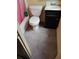 Compact bathroom features a toilet, vanity with sink, and shower with a pink curtain at 615 Weber Ave, Daytona Beach, FL 32114