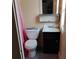 Small bathroom featuring a toilet, sink with vanity, mirror, and shower with a pink curtain at 615 Weber Ave, Daytona Beach, FL 32114