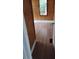 A bedroom with a window, wood paneling, modern flooring, and an open doorway at 615 Weber Ave, Daytona Beach, FL 32114