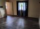 Bedroom with modern floors, a window with dark curtains, and a doorway at 615 Weber Ave, Daytona Beach, FL 32114