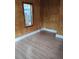 Small bedroom features wood paneling and a window providing natural light and backyard views at 615 Weber Ave, Daytona Beach, FL 32114