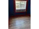 Bedroom with hardwood floors, built in shelf, and windows facing the backyard at 615 Weber Ave, Daytona Beach, FL 32114