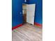 Inviting living room with vibrant blue walls, a doorway to the kitchen, and hardwood floors at 615 Weber Ave, Daytona Beach, FL 32114