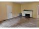 Spacious living room with new floors, a fireplace, and a white door at 615 Weber Ave, Daytona Beach, FL 32114