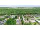 A high aerial view showcasing the home in a peaceful, verdant neighborhood with nearby industrial park at 685 N Firwood Dr, Deltona, FL 32725