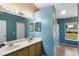 Bathroom with blue walls, double sink vanity, and shower stall at 685 N Firwood Dr, Deltona, FL 32725