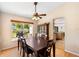 Dining room with wood table, ceiling fan, and view of backyard at 685 N Firwood Dr, Deltona, FL 32725