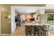 The kitchen featuring tile floors, light cabinets and seating for three at the breakfast bar at 685 N Firwood Dr, Deltona, FL 32725
