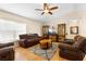 Spacious living room with wood floors, vaulted ceilings, ceiling fan and comfortable seating arrangements at 685 N Firwood Dr, Deltona, FL 32725
