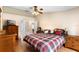 Main bedroom with ceiling fan, wood floors and ensuite bathroom at 685 N Firwood Dr, Deltona, FL 32725