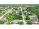 Scenic shot of a quiet neighborhood street with well-maintained homes and mature trees at 685 N Firwood Dr, Deltona, FL 32725