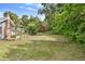 Spacious backyard with mature trees and partial fencing provides natural privacy at 710 W May St, Deland, FL 32720