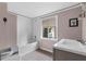 Bathroom featuring a tub with white subway tile surround and a window with natural light at 710 W May St, Deland, FL 32720