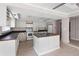 Kitchen features an open island, appliances, and white cabinets at 710 W May St, Deland, FL 32720