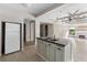 A kitchen features an island and stainless steel sink, adjacent to a living space with a fireplace at 710 W May St, Deland, FL 32720