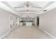Spacious living room featuring an open layout, tile flooring, and a connecting kitchen at 710 W May St, Deland, FL 32720