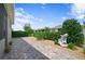 Landscaped backyard with a paver path leading to a peaceful garden area and lush greenery at 7732 Sw 86Th Ct, Ocala, FL 34481
