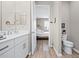 A well-lit bathroom is visible from the bedroom, featuring a white vanity and fixtures at 7732 Sw 86Th Ct, Ocala, FL 34481