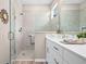 A contemporary bathroom features a walk-in shower and a white vanity with countertop at 7732 Sw 86Th Ct, Ocala, FL 34481