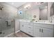 A stylish bathroom features a glass-enclosed shower and double sinks with a white vanity at 7732 Sw 86Th Ct, Ocala, FL 34481