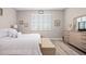 A comfortable bedroom has a bench at the foot of the bed and shuttered windows at 7732 Sw 86Th Ct, Ocala, FL 34481