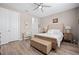 An inviting bedroom features neutral tones, a bench, and an open en-suite bathroom at 7732 Sw 86Th Ct, Ocala, FL 34481