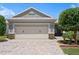 Charming home featuring a spacious garage, lovely stone accents and a beautifully landscaped yard at 7732 Sw 86Th Ct, Ocala, FL 34481
