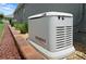 Home backup generator on a gravel bed with brick border and partial view of backyard at 7732 Sw 86Th Ct, Ocala, FL 34481