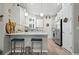 Bright kitchen featuring white cabinets, modern appliances, bar seating, and ample counter space at 7732 Sw 86Th Ct, Ocala, FL 34481