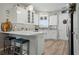 Modern kitchen with white cabinets, stainless steel appliances, and bar seating at 7732 Sw 86Th Ct, Ocala, FL 34481