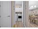 Bright laundry room with white cabinets and modern appliances, conveniently located off the hallway at 7732 Sw 86Th Ct, Ocala, FL 34481