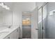 Bright bathroom featuring double vanity, blue tiled shower, and access to the bedroom at 822 W 24Th St, Sanford, FL 32771